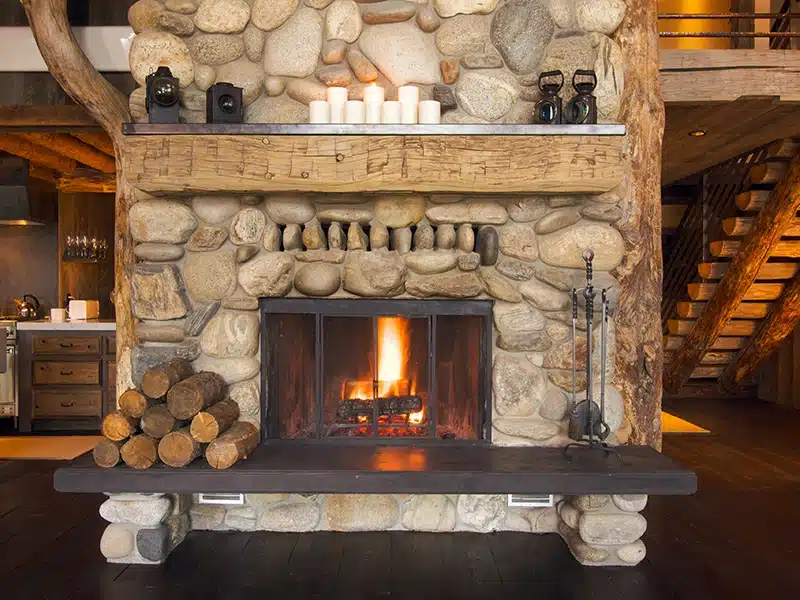 A stone fireplace in a cabin