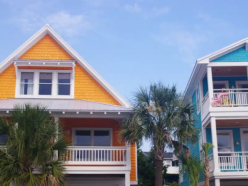A yellow and teal beach house exterior