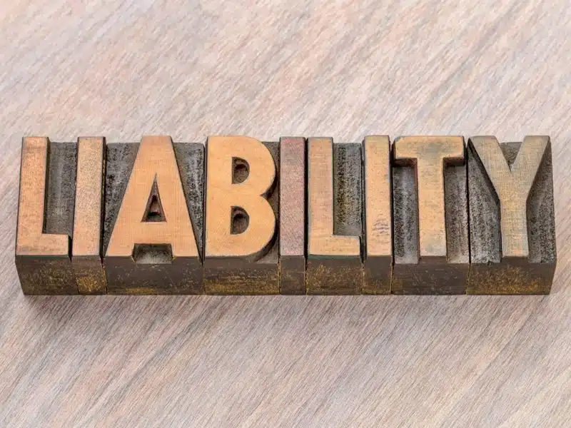 The word "liability" spelled using letterpress blocks.