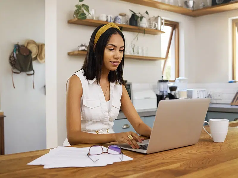 Woman works remotely from laptop