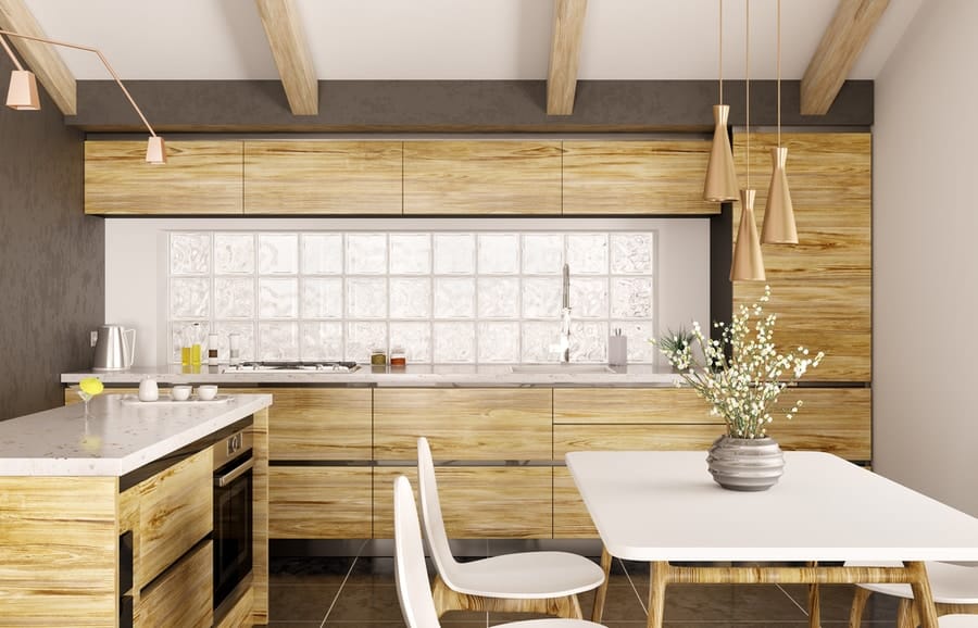 A modern-styled kitchen with wooden cabinets and white table and chairs.