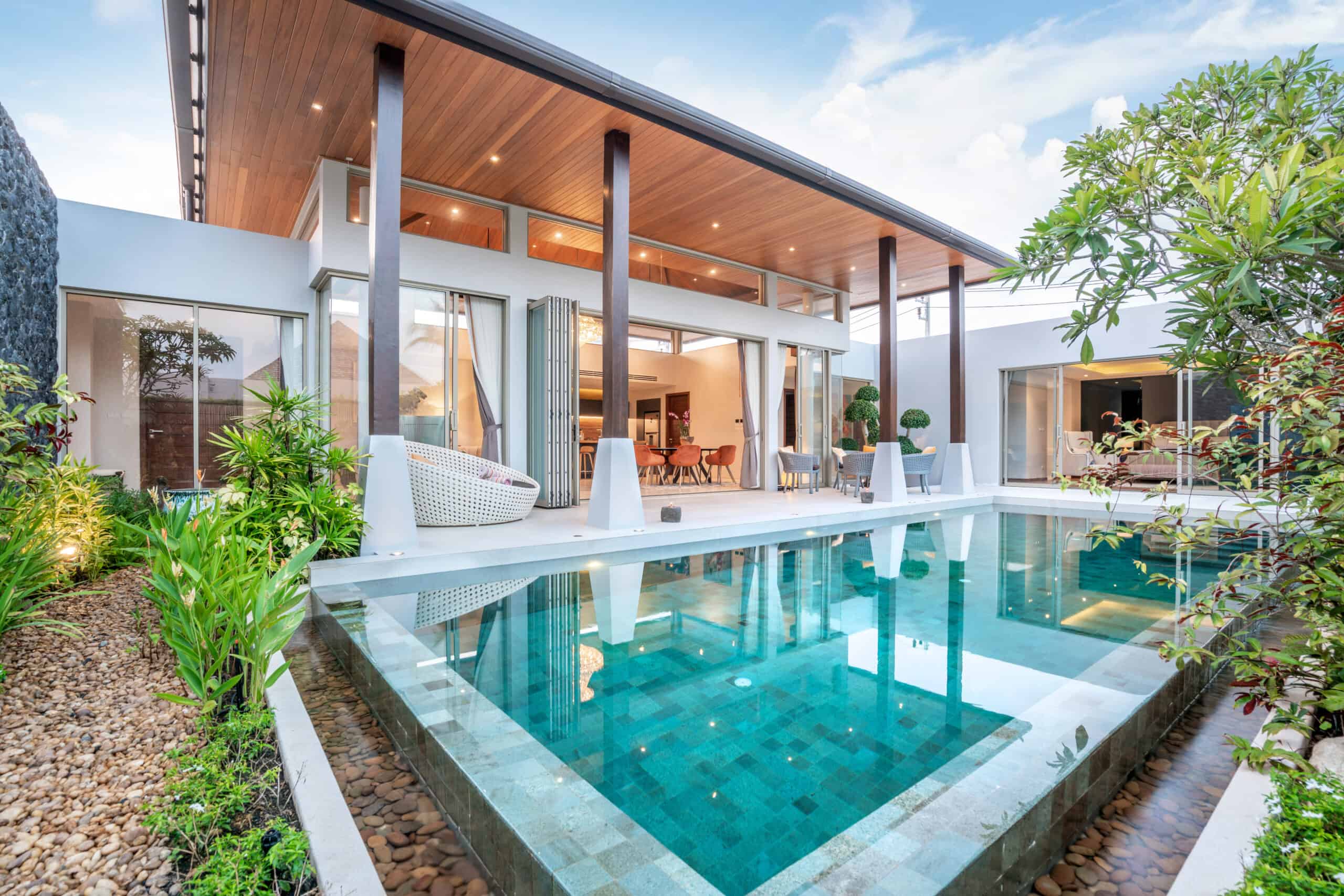 the backyard of a modern home with an infinity pool.