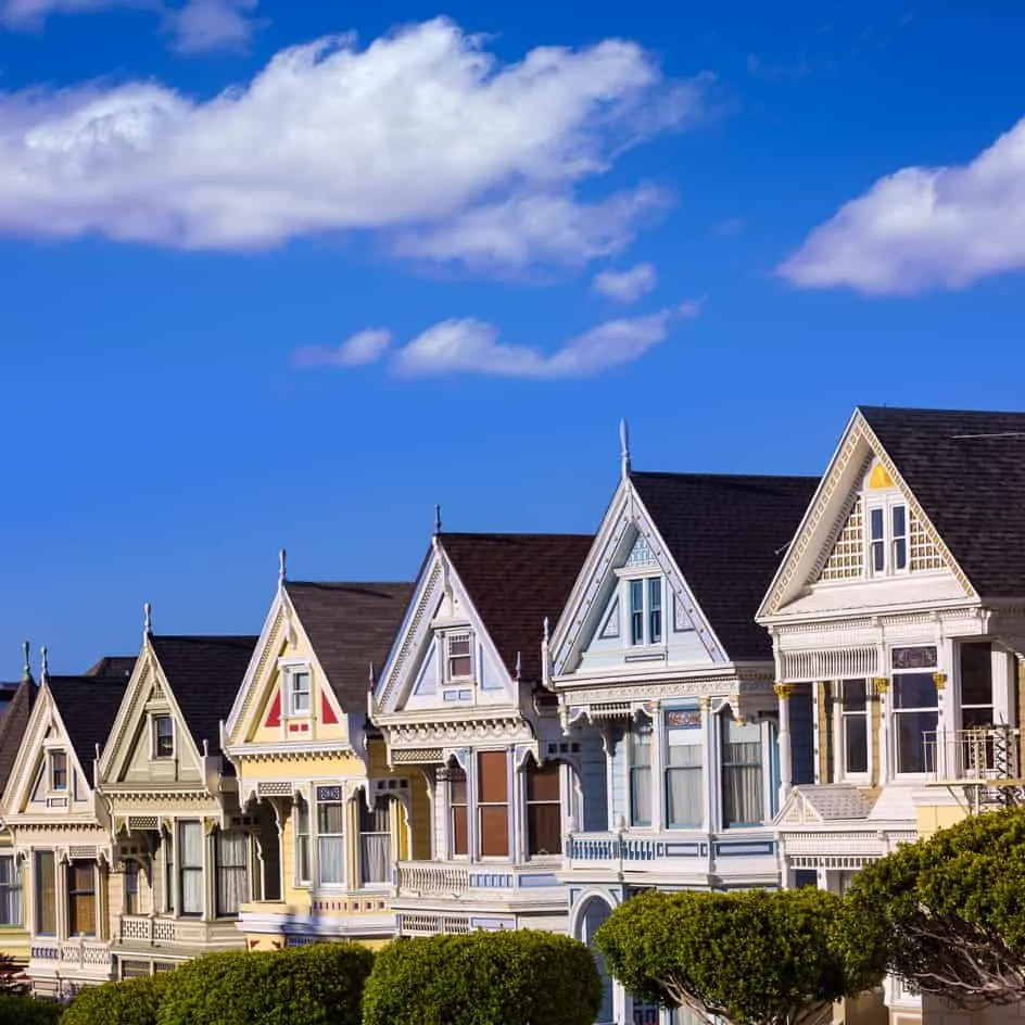 A row of colorful houses under a clear blue sky.