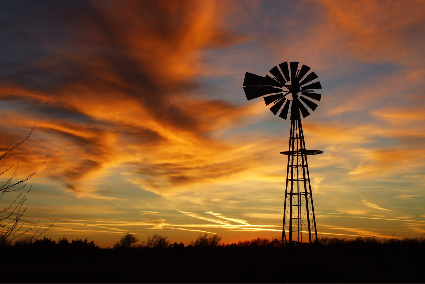 Sunset picture of an old style windmill in Kansas.