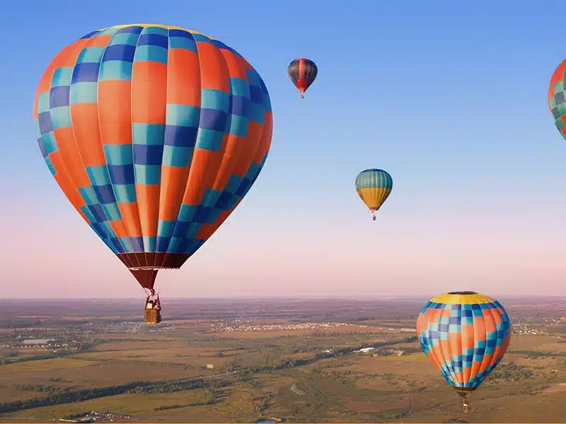 A picture of orange and blue hot air balloons