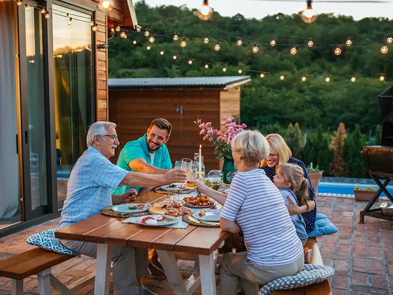 A family enjoys dinner outside an Airbnb home